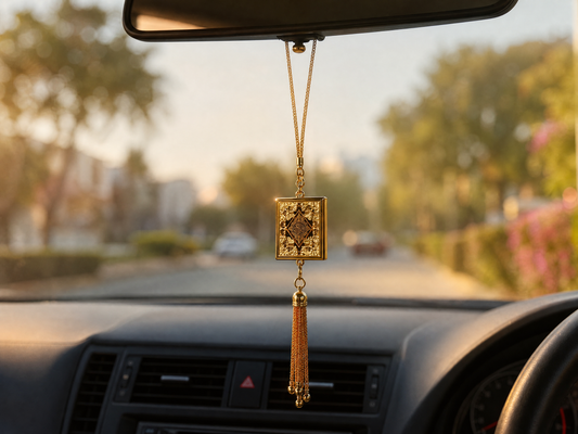 Gold mini Quran car hanging ornament with tassel on a car rear-view mirror