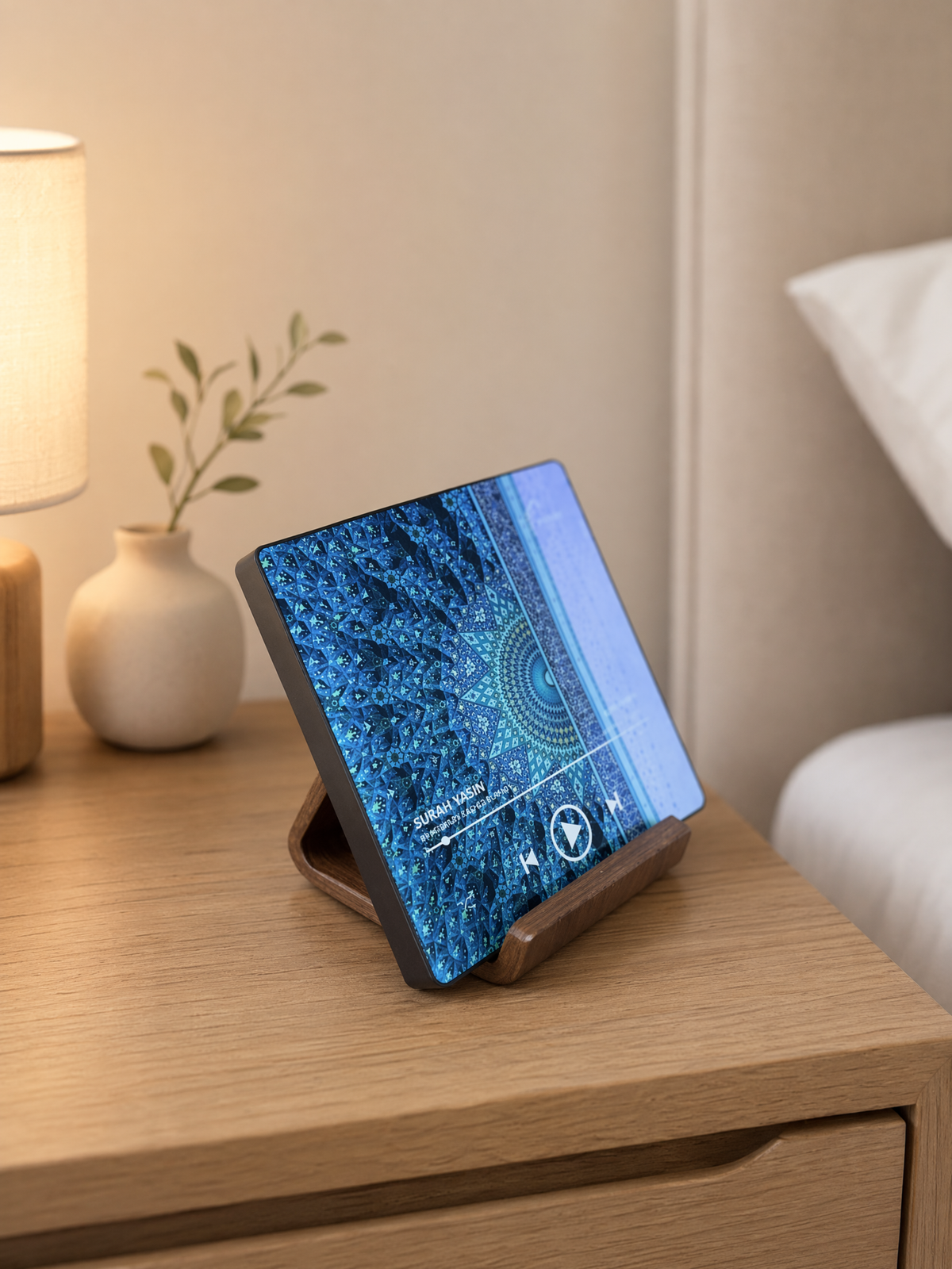 Quran speaker magnet displayed on an Ayahly wooden stand on a bedside table