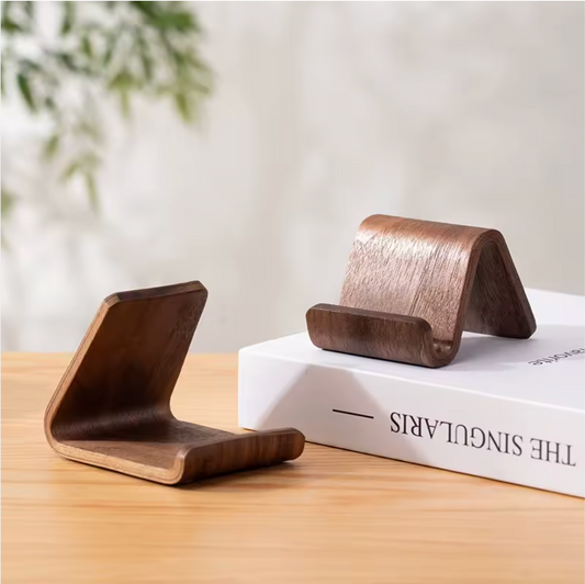 Two walnut Ayahly stands for Quran speaker magnets resting on a book on a desk